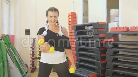 健身房里的一个女人训练她的手臂肌肉以适应女性的运动为背景这是一位运动女性视频的预览图