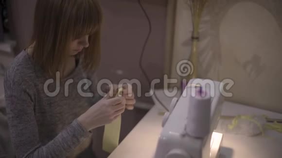 女时装设计师裁缝裁缝裁缝晚上在家里做缝纫机红发女工视频的预览图
