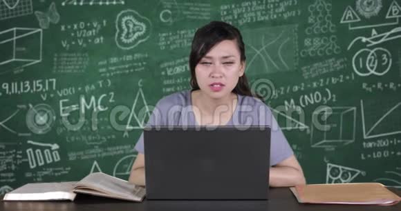 女学生使用笔记本电脑和举手视频的预览图