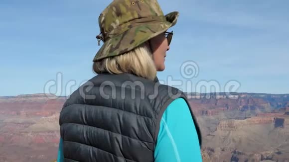 女徒步旅行者从高处欣赏大峡谷的景色视频的预览图