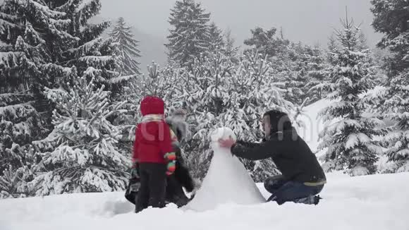 家庭肖像建造快速美丽的雪人时间流逝团队合作视频的预览图