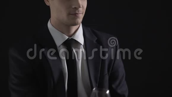 年轻的成功商人喝着白兰地酒杯庆祝成功的交易视频的预览图