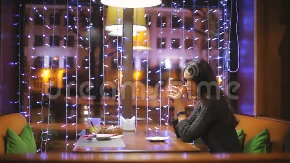 悲伤的女孩独自在咖啡馆里视频的预览图