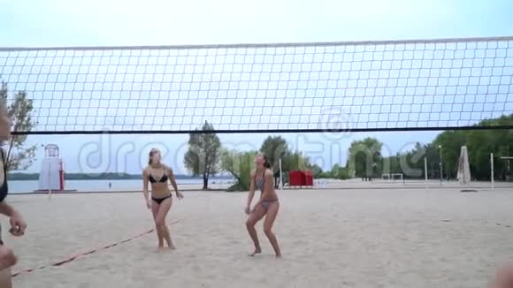 四个女人在沙滩上打排球跳来跳去打着球视频的预览图