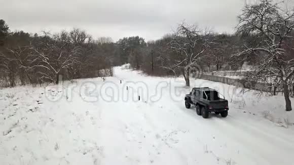 从鸟瞰s视野的SUV6x6它在冬天沿着乡村道路行驶顶部视图视频的预览图
