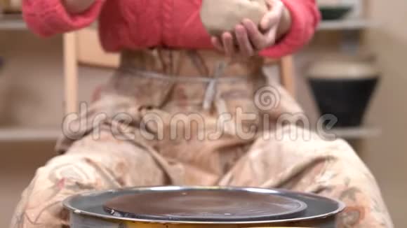 陶工在陶瓷车间里把一块粘土放在陶工的轮子上视频的预览图