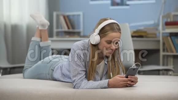可爱的少女戴耳机听音乐放松时间视频的预览图