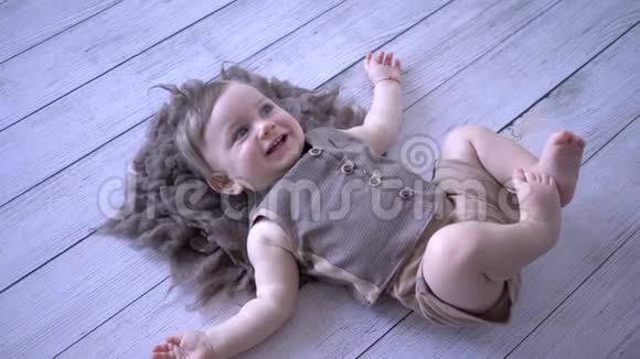 快乐的童年活泼的幼儿躺在地上微笑视频的预览图