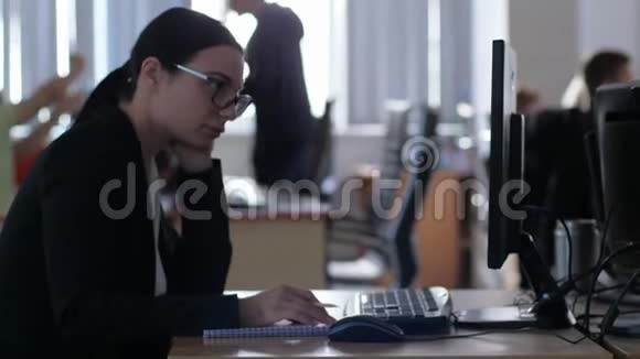 压力管理疲惫的女商人戴着眼镜一边拿着铅笔一边用电脑坐在办公桌前视频的预览图