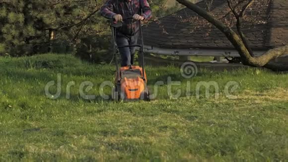 成年男子电动割草机割草机园丁修剪花园视频的预览图