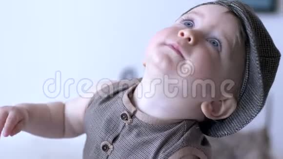 幼儿时期快乐的宝宝蓝眼睛张开嘴戴着帽子特写视频的预览图