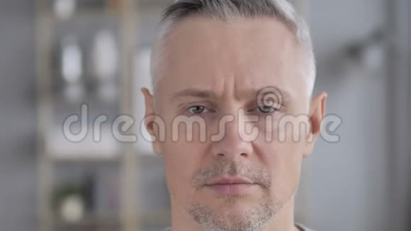 严肃的灰发男人的脸视频的预览图