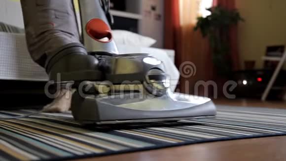 人家务和家务的概念在家里用双腿盖上真空清洁地毯的女人视频的预览图