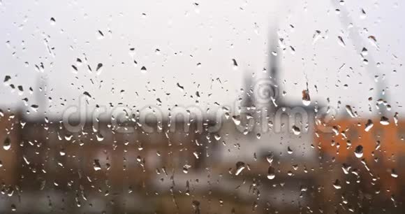 窗玻璃上的雨点背景中的建筑物视频的预览图