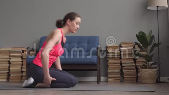 年轻的健身妇女在孩子身上做伸展运动她在家里的垫子上摆姿势视频的预览图