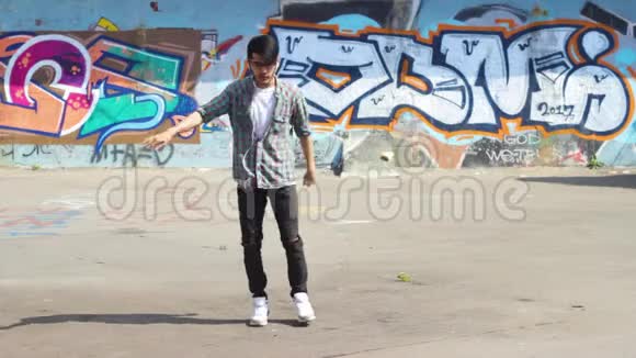 休闲亚洲现代男子戴耳机在街头跳舞视频的预览图