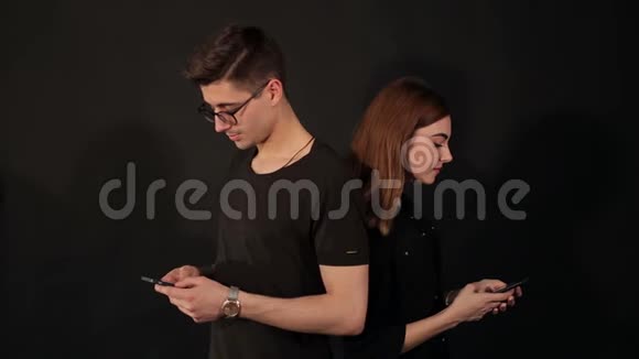 两个青少年用黑色手机的肖像视频的预览图