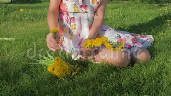 一个女人坐在草坪上编织着一个花圈蒲公英视频的预览图
