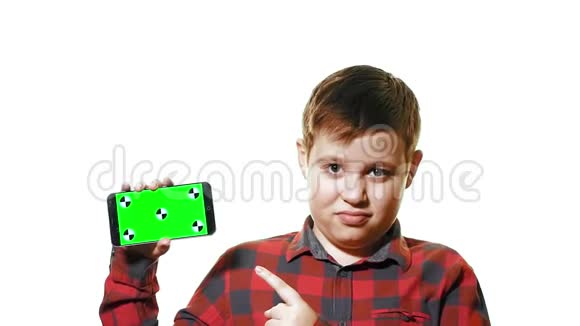 开朗的男孩手里拿着一部智能手机手里拿着一个绿色的屏幕屏幕上显示着一个手指视频的预览图