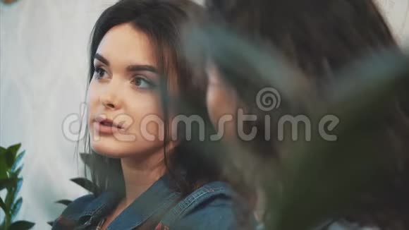 快乐美丽的女孩和她的女朋友坐在咖啡馆里在这期间讲个故事一起享受时光视频的预览图