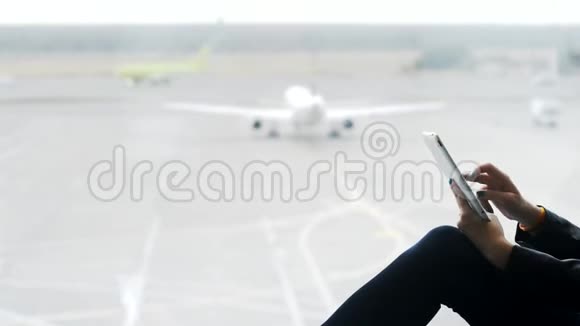 在机场使用现代平板电脑的年轻女性视频的预览图
