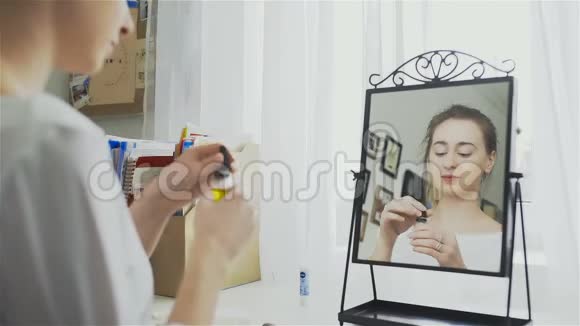 年轻女子脸上涂油液的画像视频的预览图