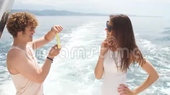 年轻摄影师在海船上给女友拍照视频的预览图