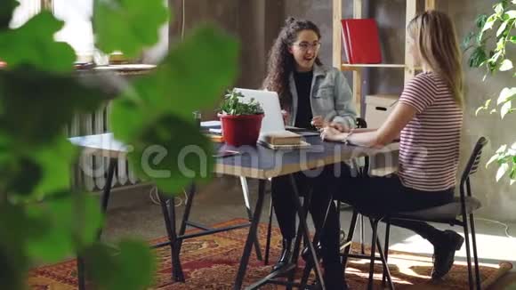 年轻的企业家在现代办公室里坐在桌旁时正在玩弄广告策略女人在说话视频的预览图