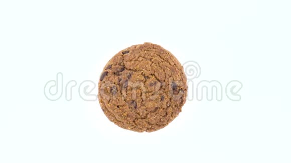 从上面可以看到旋转在转盘上的一个柔软而有嚼劲的巧克力片燕麦片饼干孤立在视频的预览图