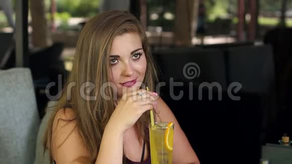 夏日街头咖啡馆里一个体重超标的小甜妹儿喝着清凉的柠檬水视频的预览图