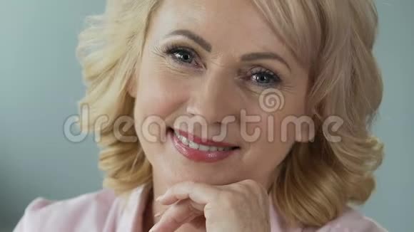迷人的中年女性完美的化妆微笑成相机特写视频的预览图