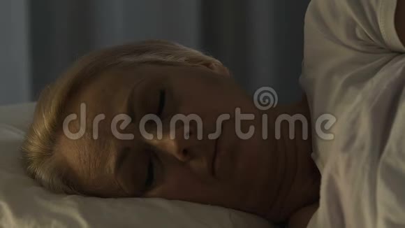 担心成熟的女性睡在她的坏痛苦的心痛特写视频的预览图