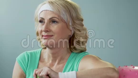 老年女士靠在健身球上喝水呼气结果视频的预览图