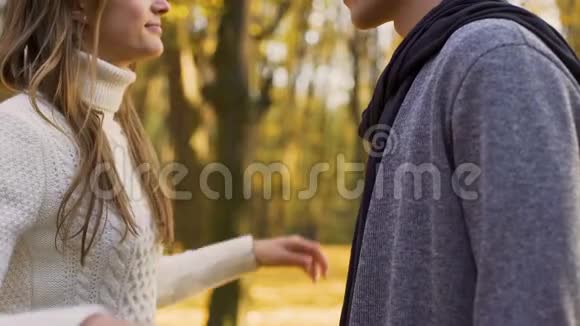 女朋友轻轻地搂着男朋友的脖子亲吻秋天的约会视频的预览图