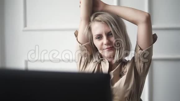 年轻的商务女性伸展手臂在工作时间微笑着心情愉快女性辛勤工作视频的预览图