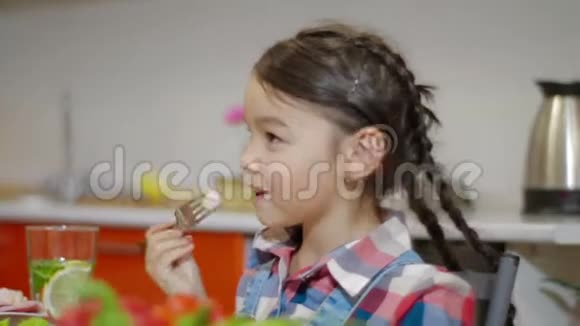 小女孩微笑着和家人共进晚餐视频的预览图