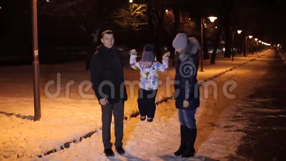 晚上在冬季公园散步的快乐家庭视频的预览图