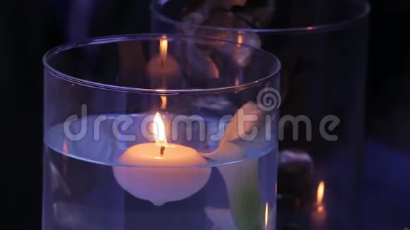 晚上晚些时候在户外举行的婚礼上瓶中的蜡烛和玻璃盒浪漫的灯光视频的预览图