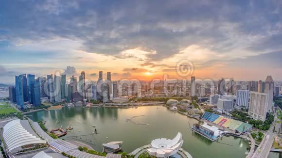新加坡滨海湾的全景金融区摩天大楼在日落的灯光下反射在港口的时间流逝视频的预览图