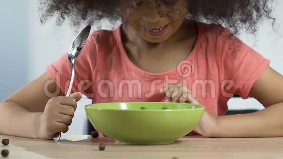 兴奋的孩子看着落下的巧克力麦片准备吃心爱的食物视频的预览图