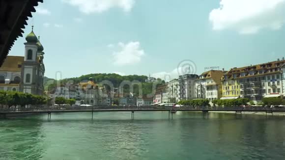 阳光明媚的一天在瑞士卢泽恩人们在桥上散步欣赏古老城镇建筑的美丽全景视频的预览图