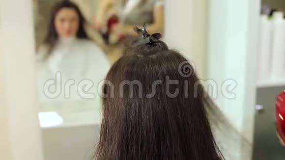 美发师在美容院里把深色长发擦干视频的预览图