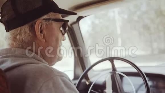 后视角的老人在镜头前打招呼从车里出来视频的预览图