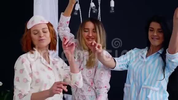 女子睡衣派对三位美女和女孩在床上欢笑跳舞庆祝母鸡聚会视频的预览图