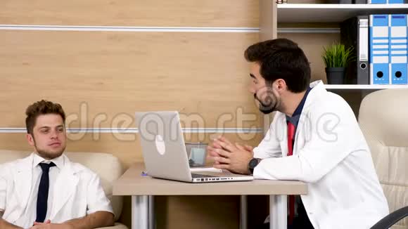 两个办公室的医生同事在谈话视频的预览图