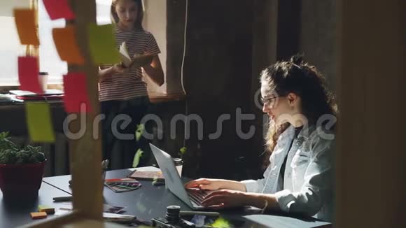 两个有魅力的女孩在现代阁楼办公室一起工作Curly女商人坐在视频的预览图