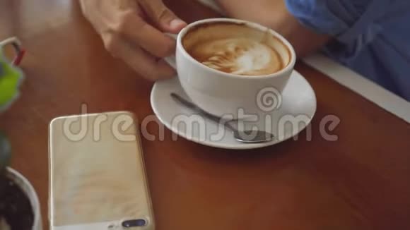 两个女人在咖啡馆里分享咖啡在咖啡杯上近距离拍摄视频的预览图