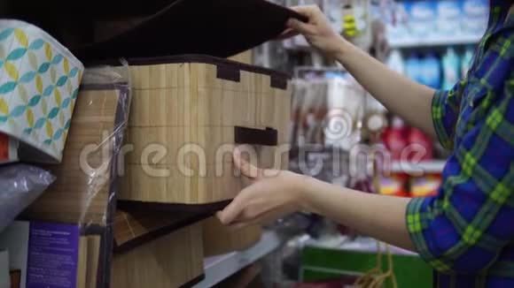 一个年轻的女人为超市里的东西选择并买了一个折叠盒视频的预览图
