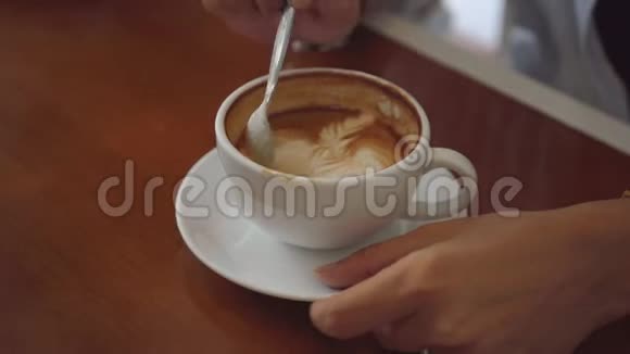 两个女人在咖啡馆里分享咖啡在咖啡杯上近距离拍摄视频的预览图