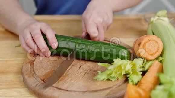 闭上雌性的手切黄瓜芹菜和胡萝卜视频的预览图